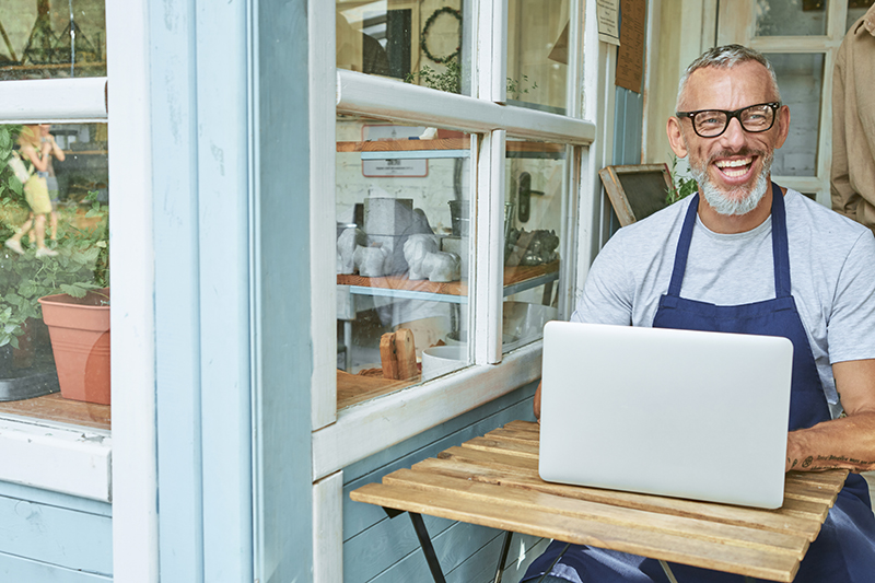 Small business owner running their shop with confidence using ourCMO