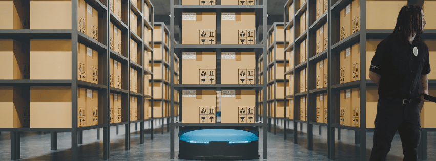 Professional security guard monitoring a busy warehouse and distribution center