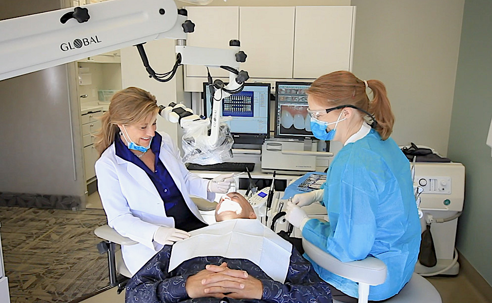 Happy patient in dental office background