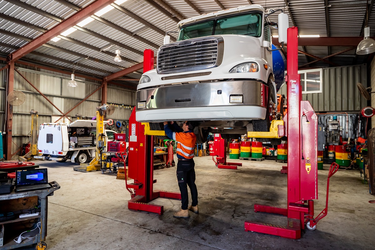 Expert heavy diesel mechanic inspecting a truck