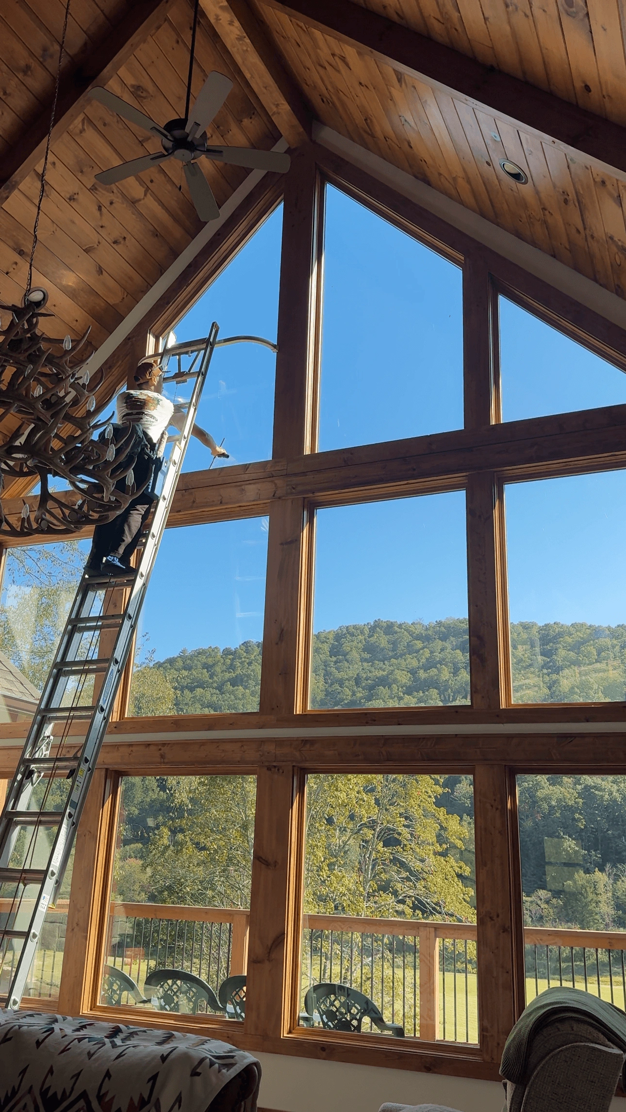 Professional window cleaning on a High Country mountain home with floor-to-ceiling glass