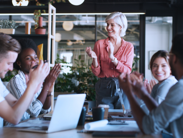 Nonprofit team celebrating success in a modern office