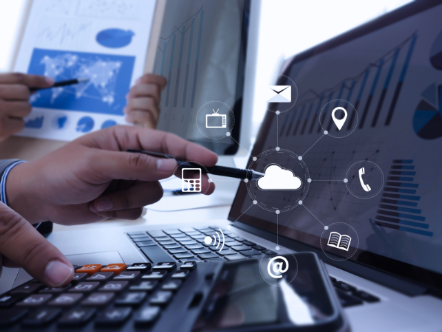 Business professionals analyzing cloud technology and data on laptops