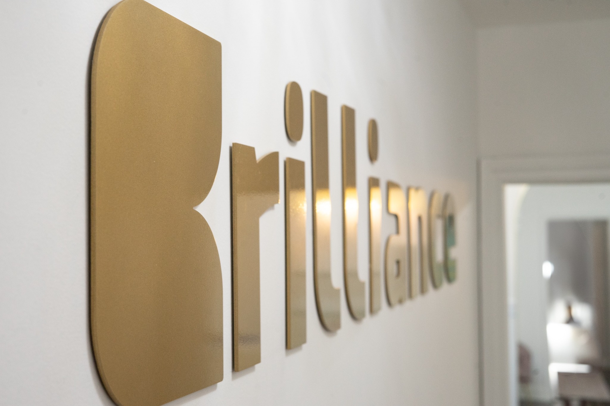 Brilliance Medical Aesthetics gold wall logo