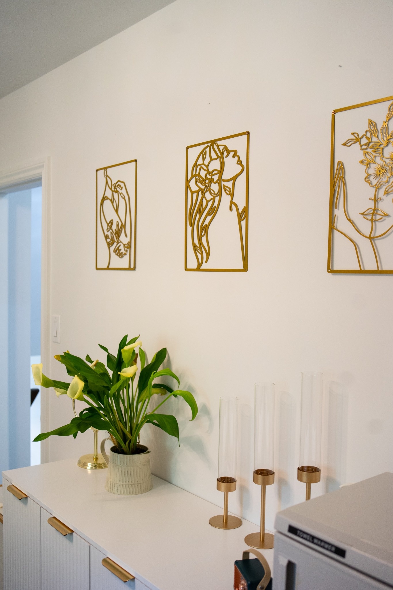 Brilliance clinic interior with flowers, gold artwork, and white cabinetry