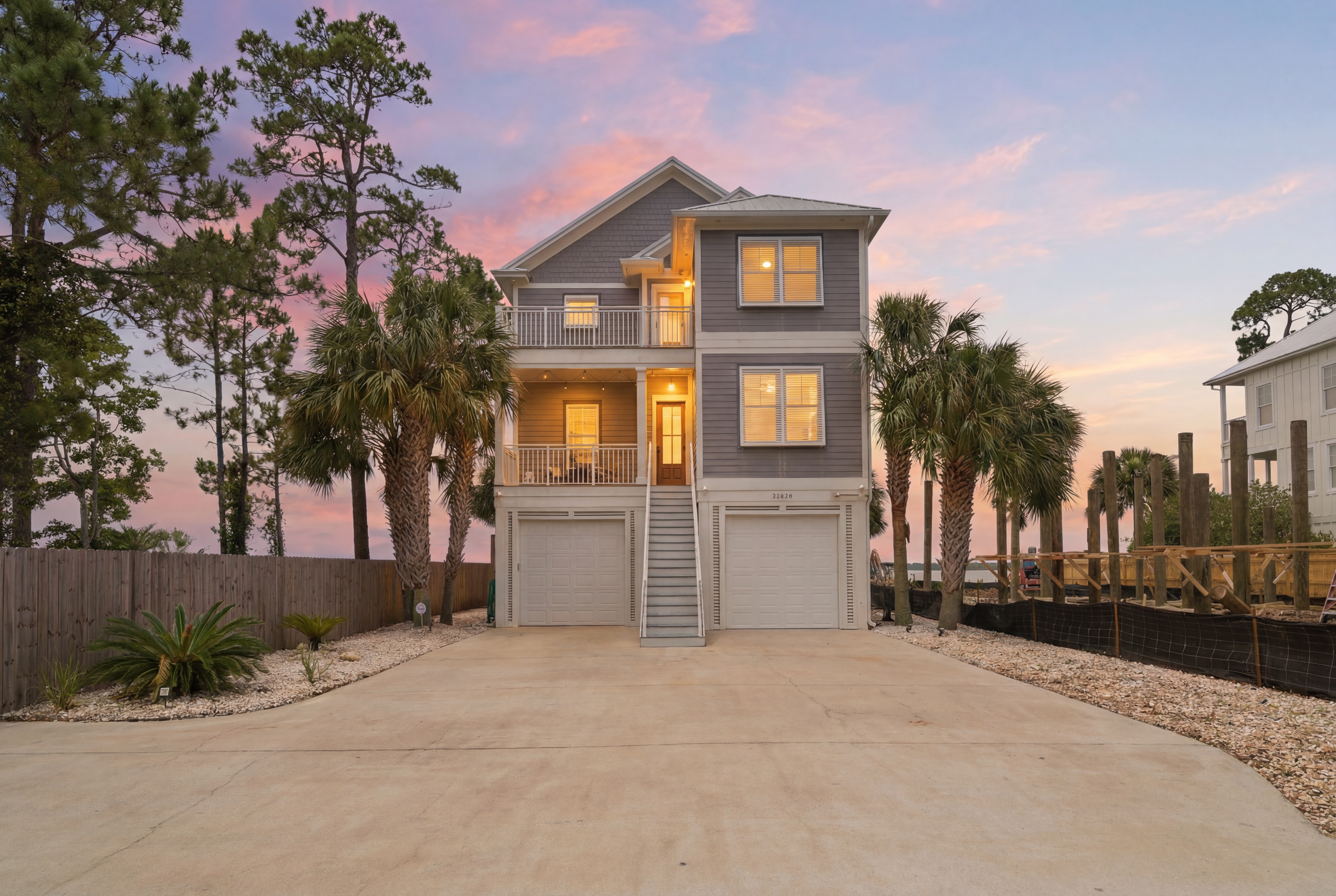 Twilight view of the front exterior of the luxury home in Orange Beach, Alabama