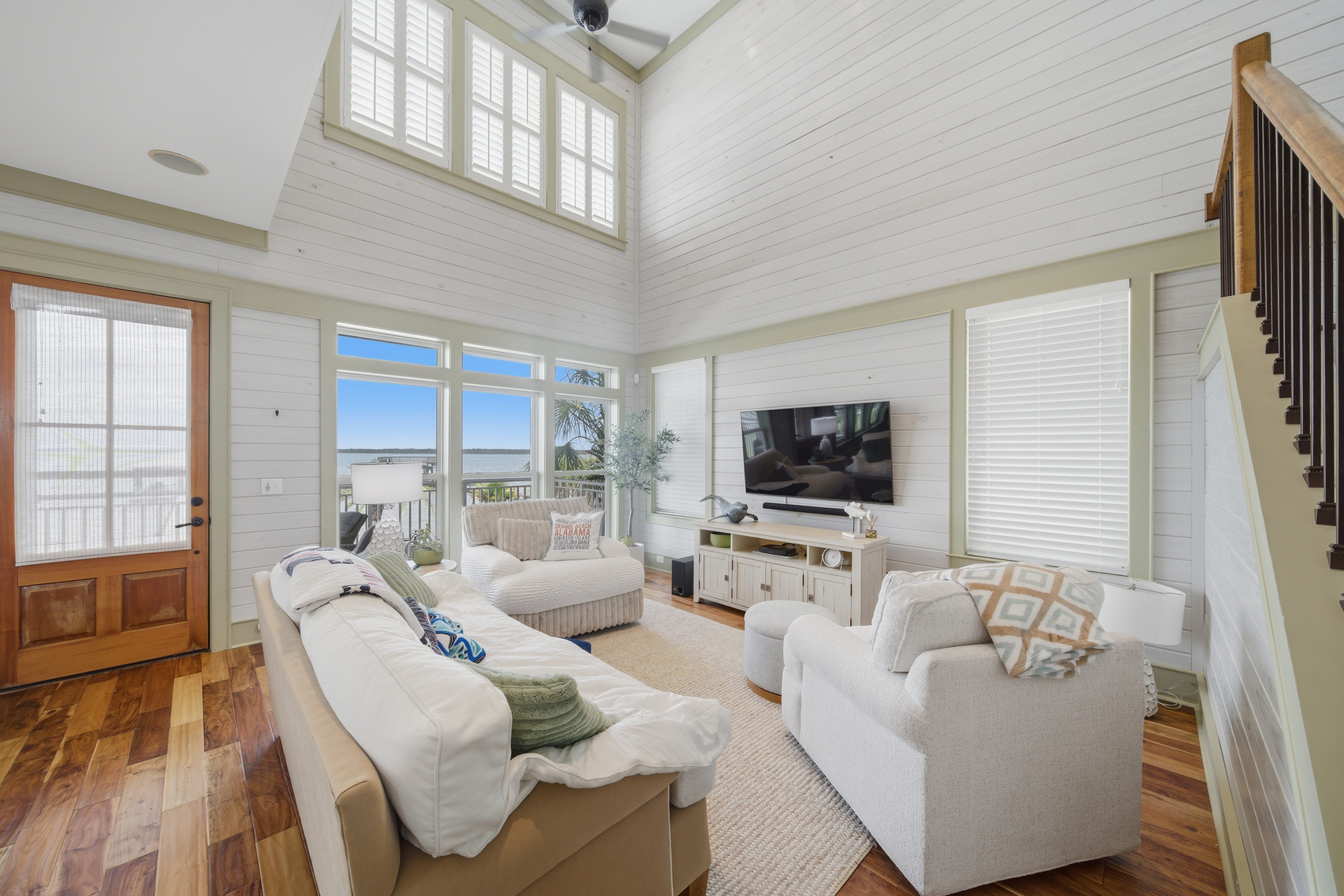 Luxurious coastal living room with high ceilings