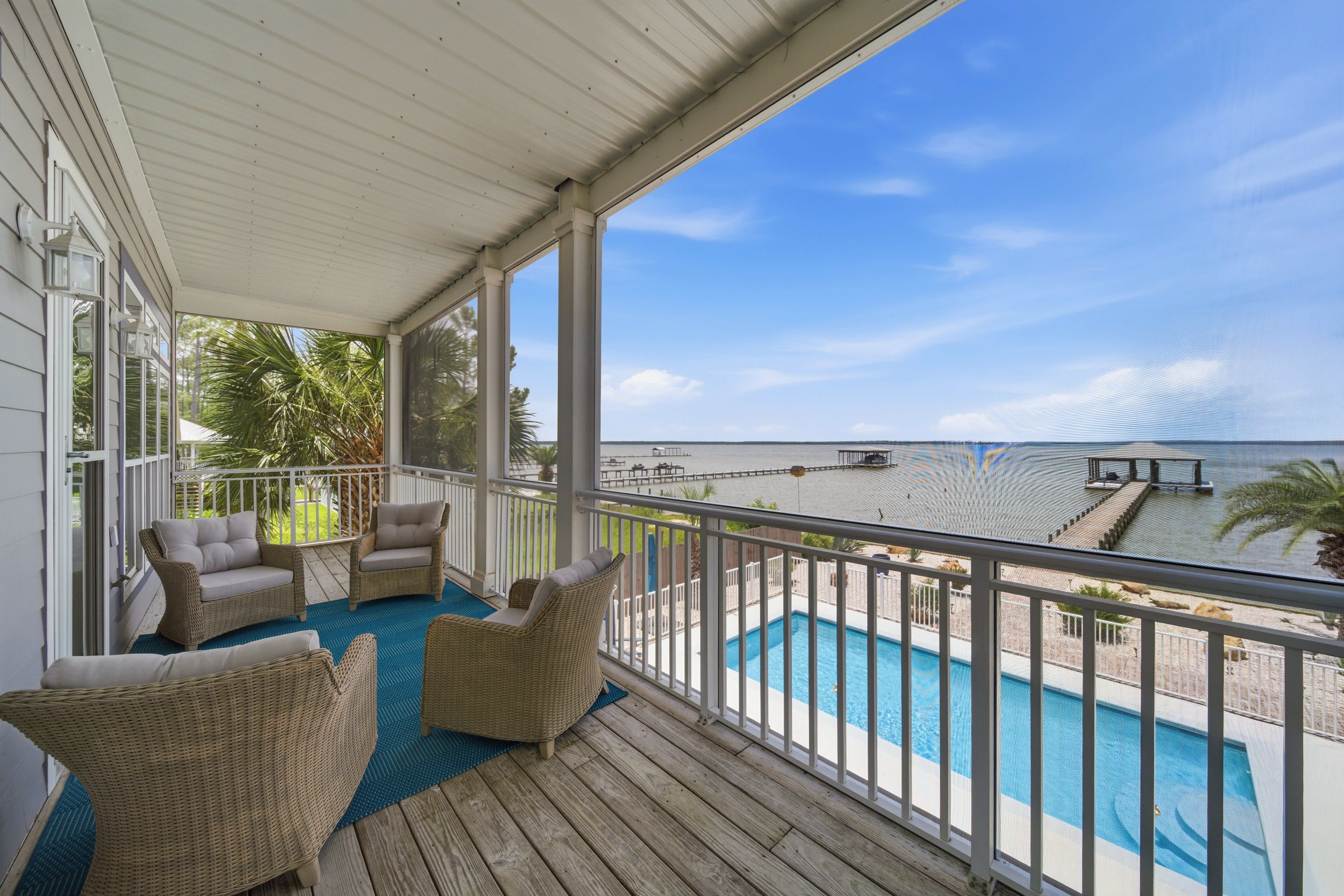 Covered porch overlooking the pool and water
