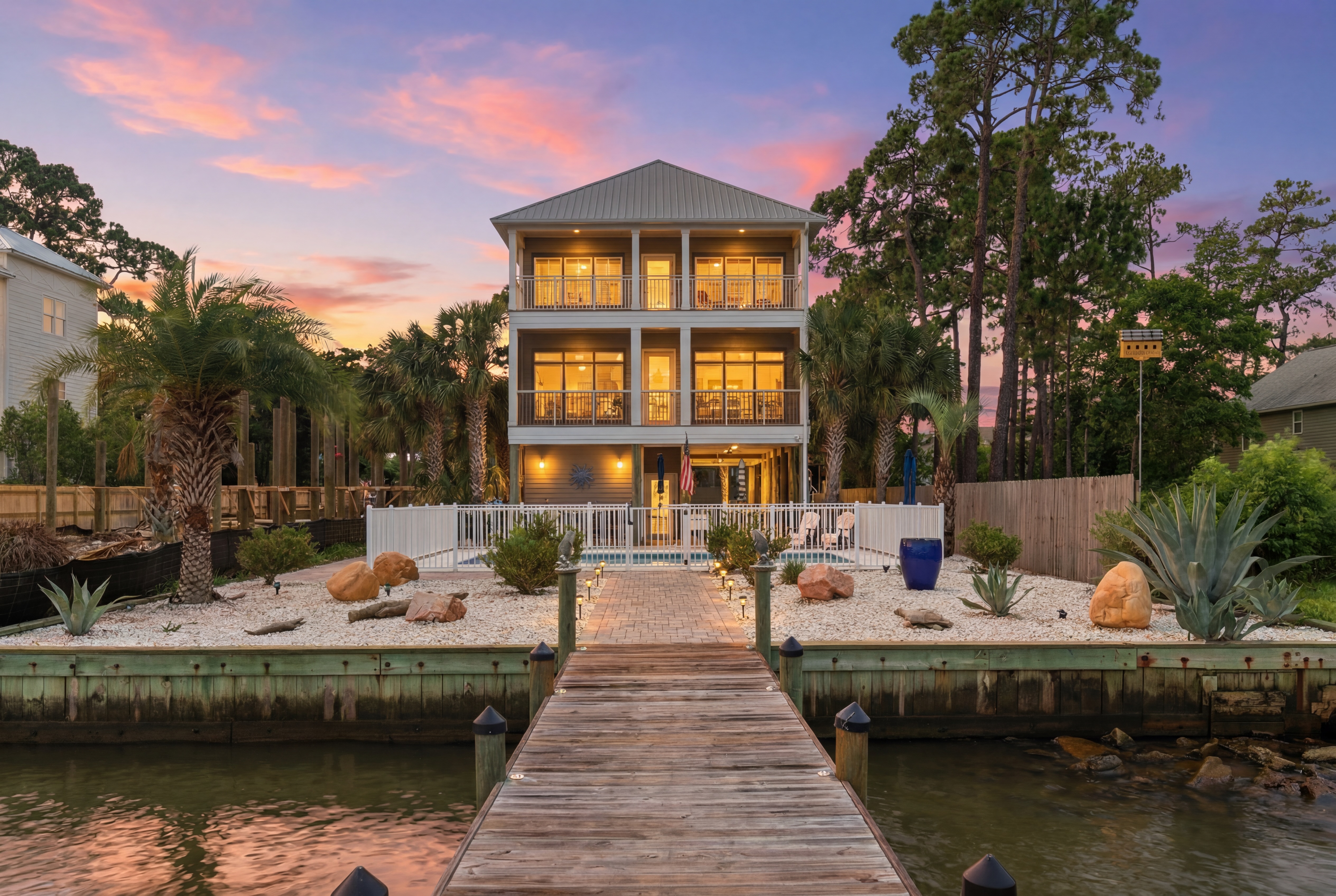 Twilight view of the waterfront home from the dock
