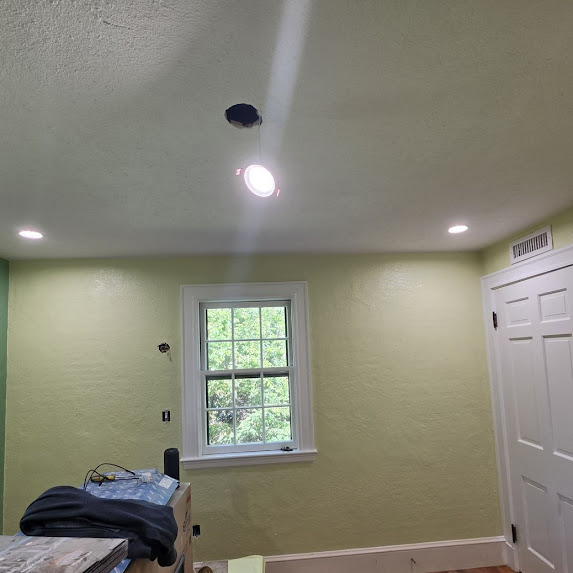 Light green painted room with window and ceiling light