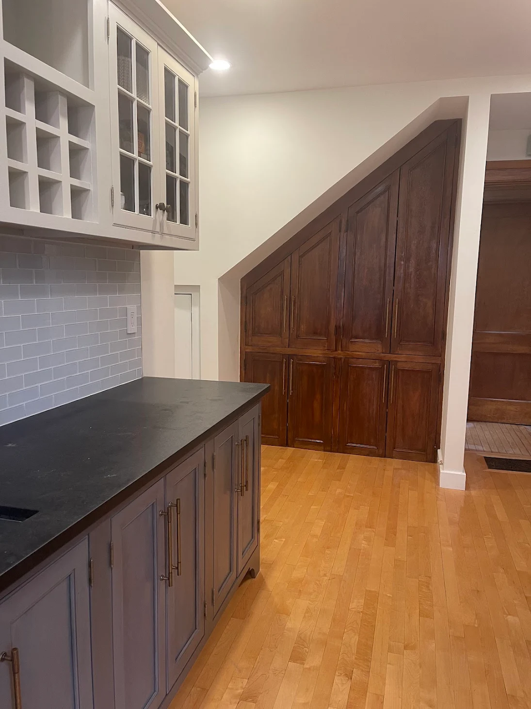 Painted lower cabinets in blue-gray with wood built-ins