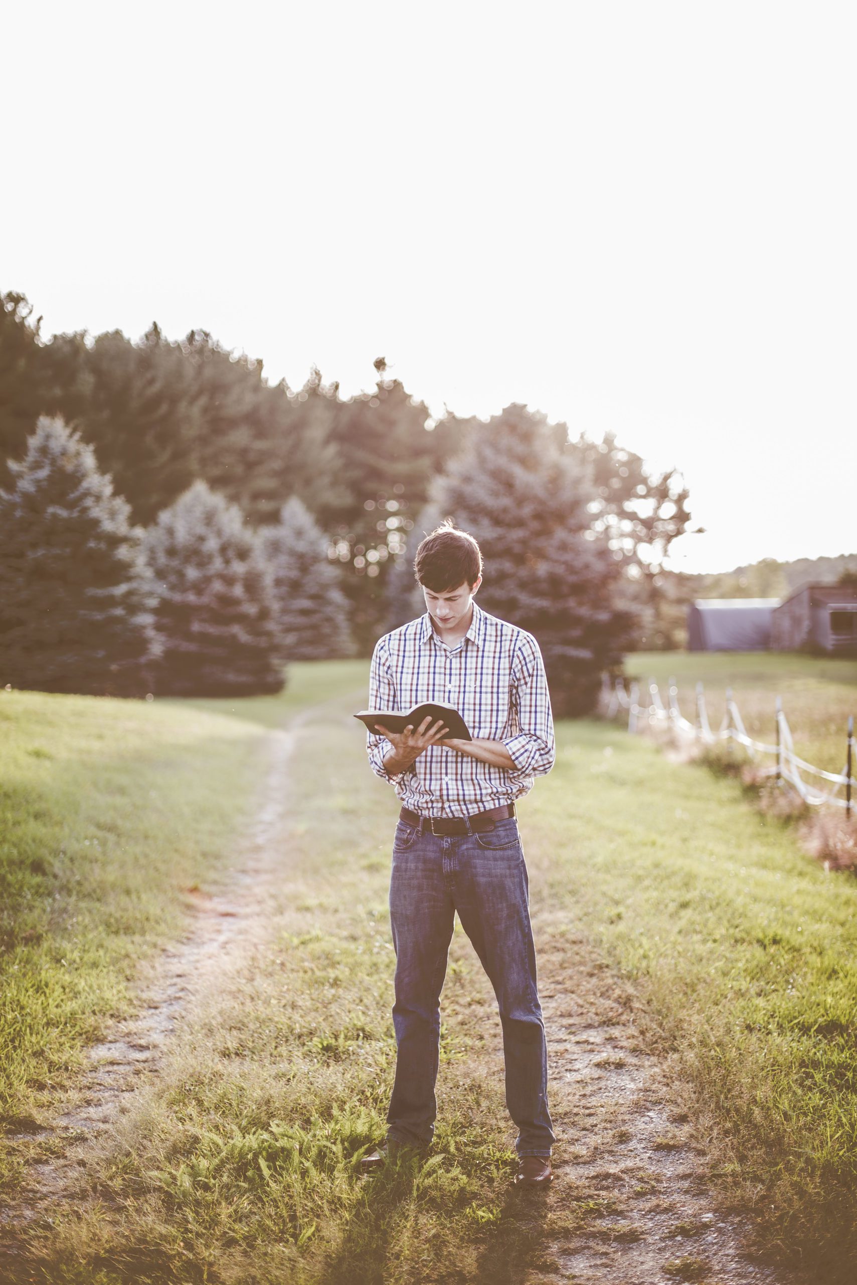 Man reading Bible outdoors