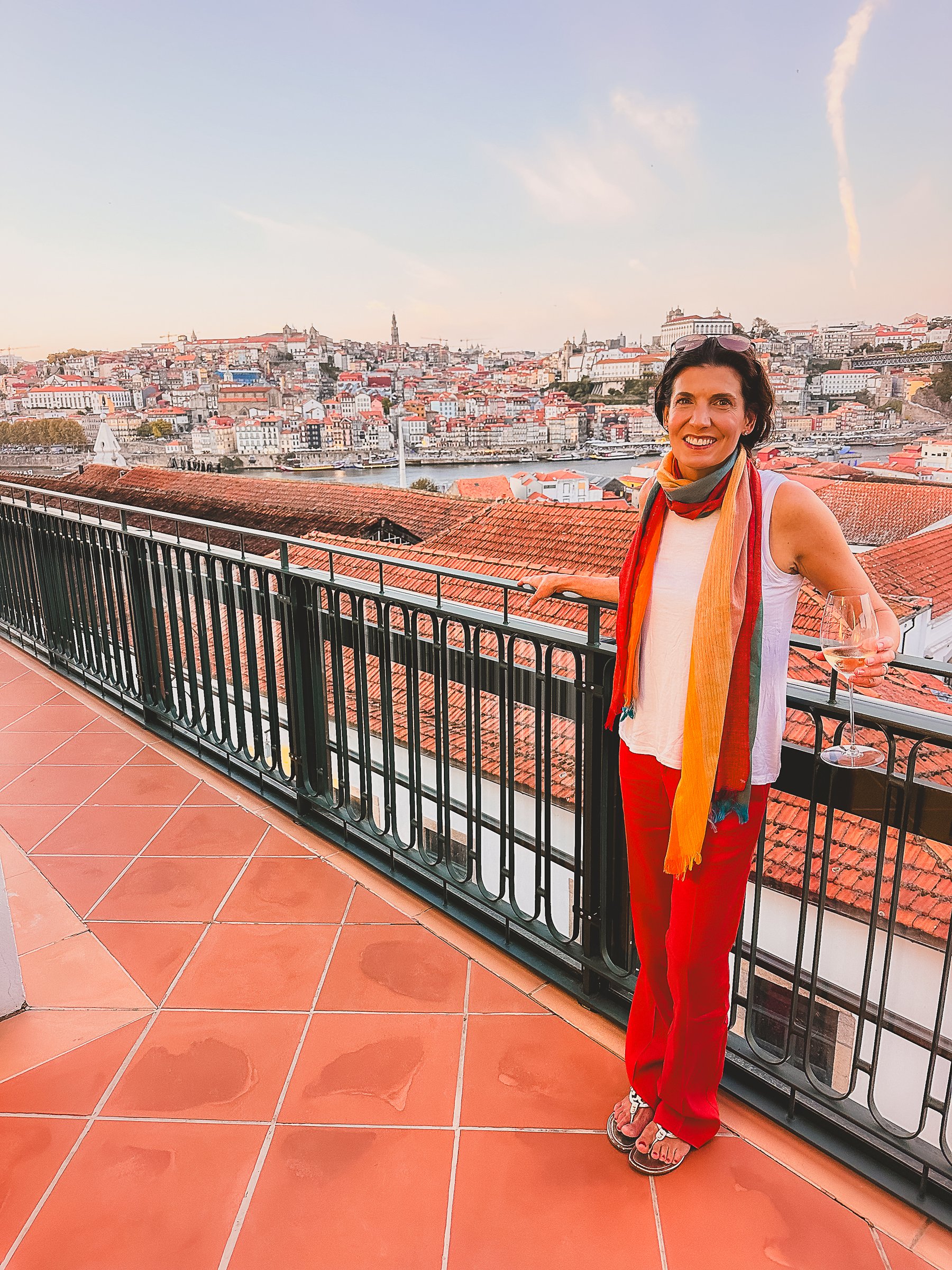 Erin, travel advisor, with a glass of wine overlooking Porto, Portugal