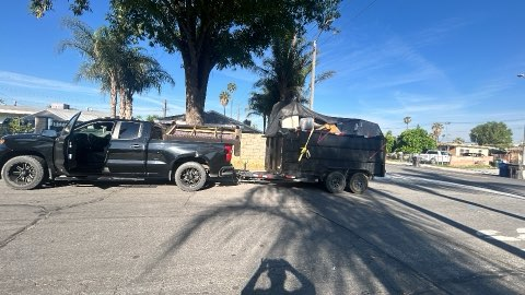 Truck and dump trailer parked on street