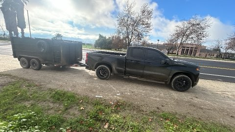PC Junk Removal truck with dump trailer on the road
