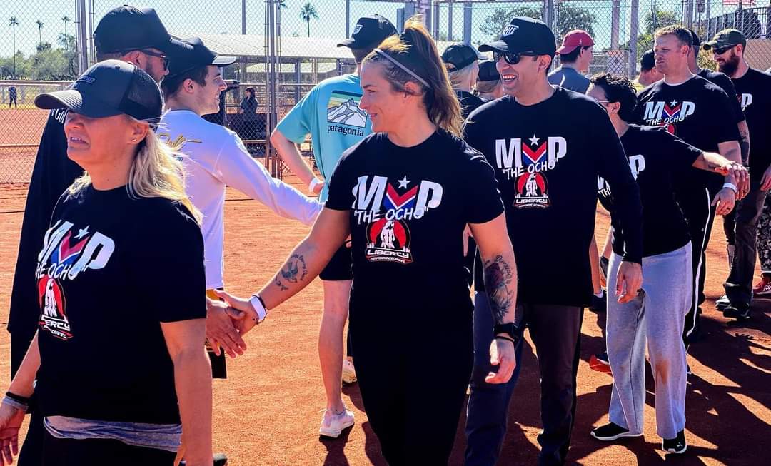 Teams doing high-fives and showing sportsmanship after the kickball game