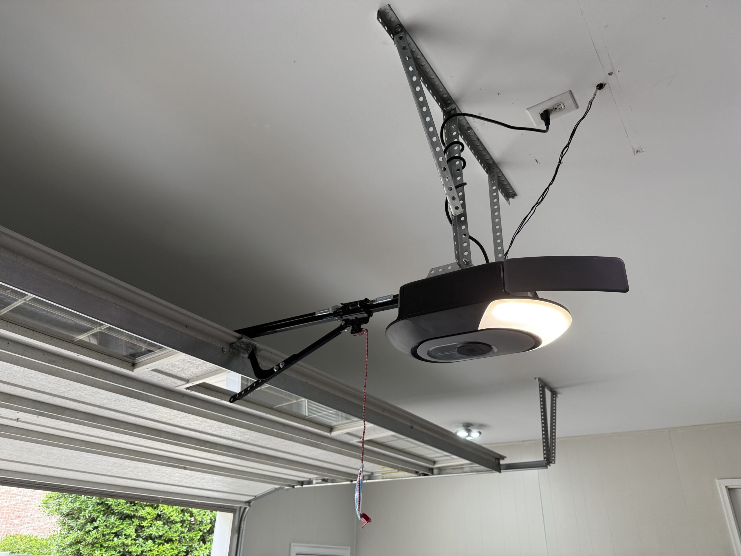 Chamberlain garage door opener motor unit with rail and bracket installed on ceiling by Garage Door Gators in Mint Hill NC
