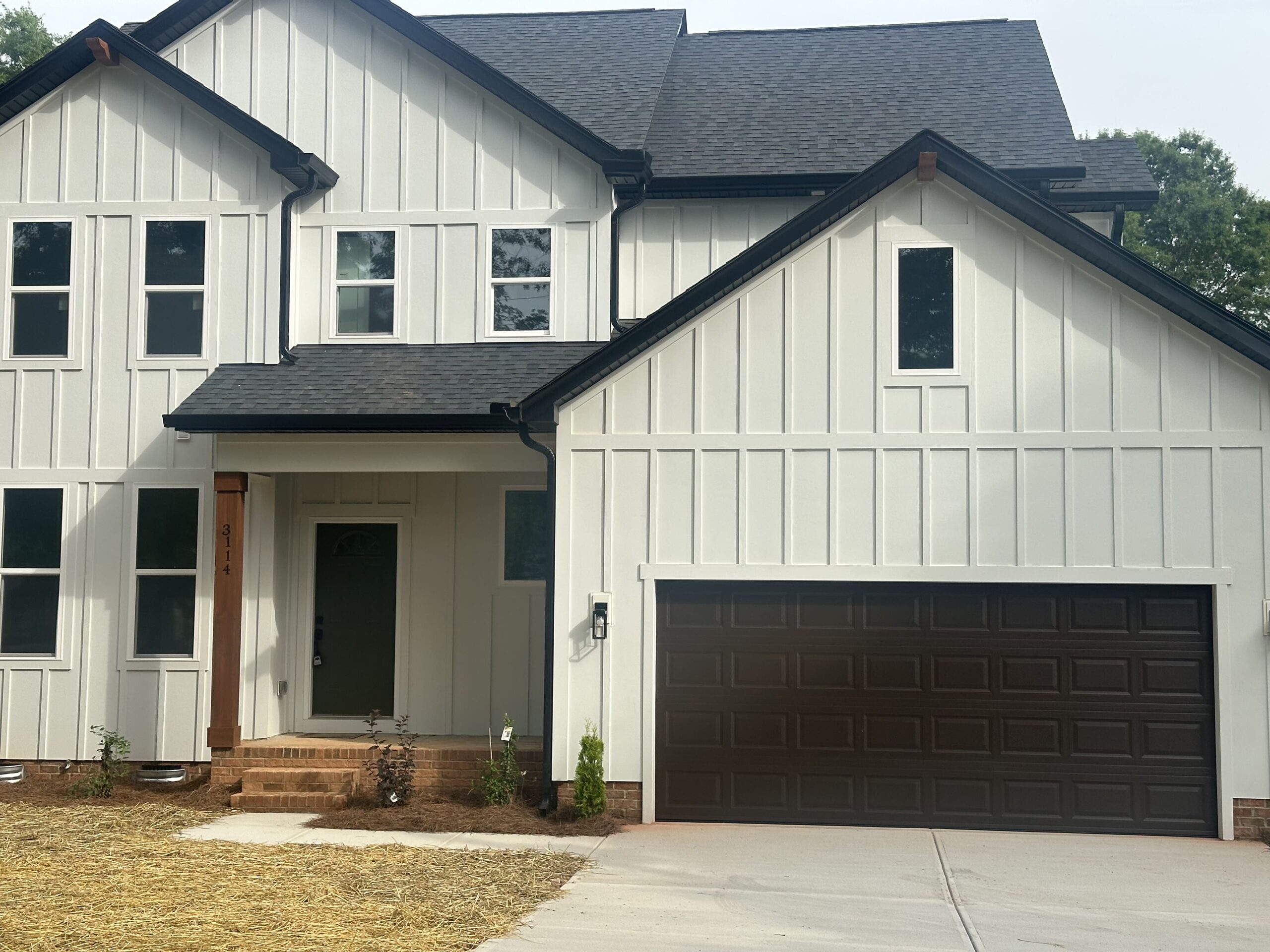 New dark brown steel garage door installed by Garage Door Gators on a modern farmhouse in the Mint Hill NC area