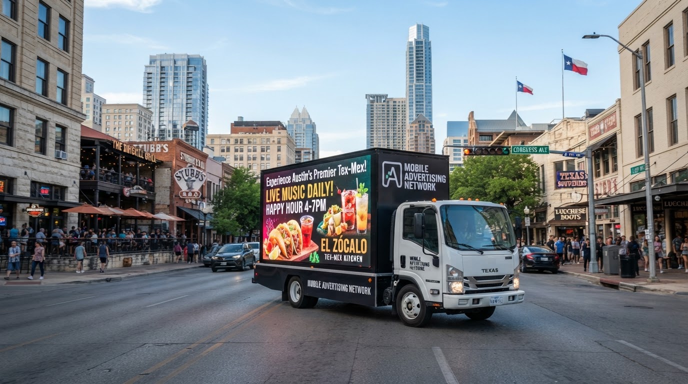 Motivo LED mobile billboard truck driving through a vibrant Texas business district with restaurants, retail, and event venues for industry-specific mobile advertising