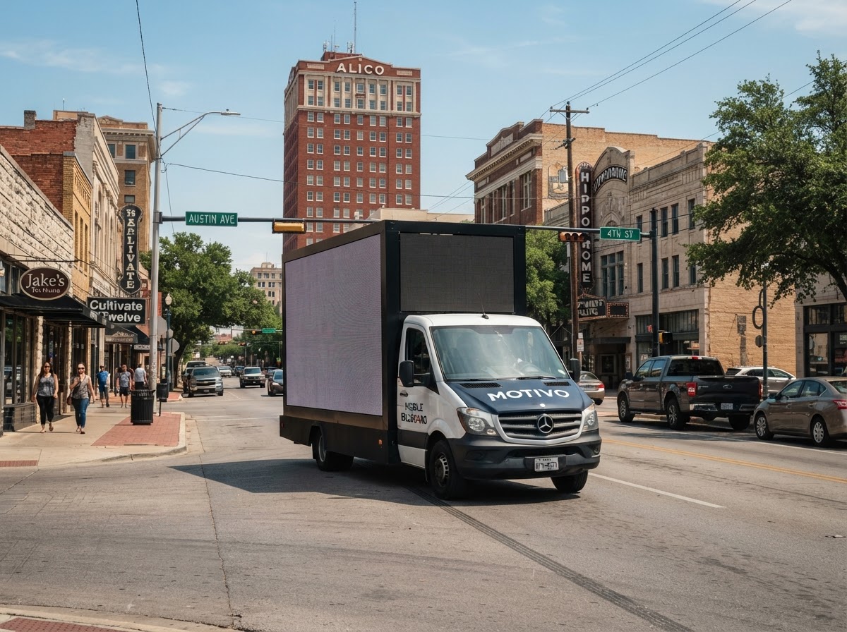 Motivo mobile billboard truck in Downtown Waco, Texas during the day with Central Texas commercial buildings