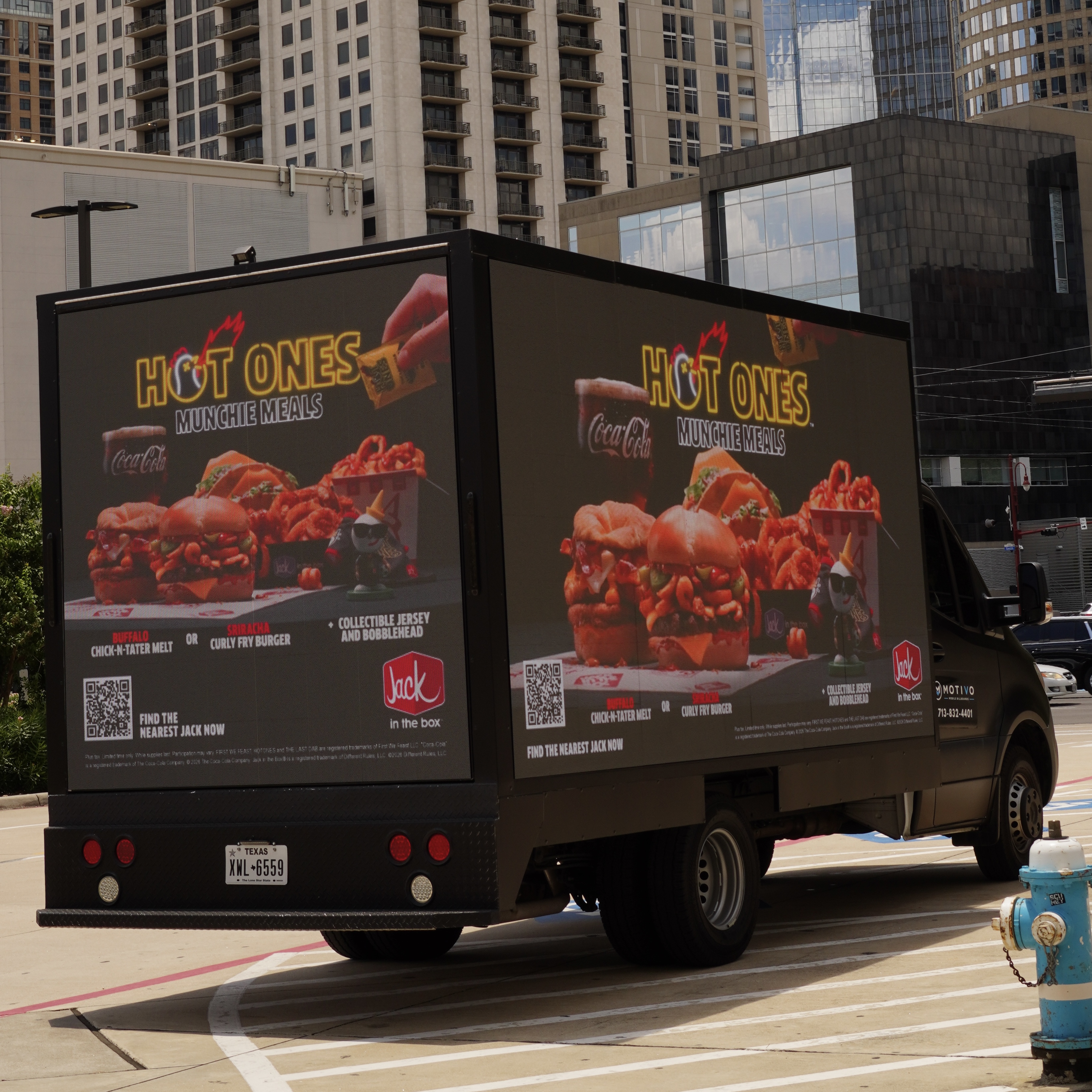 Motivo digital billboard truck promoting Jack in the Box Hot Ones campaign through downtown Houston