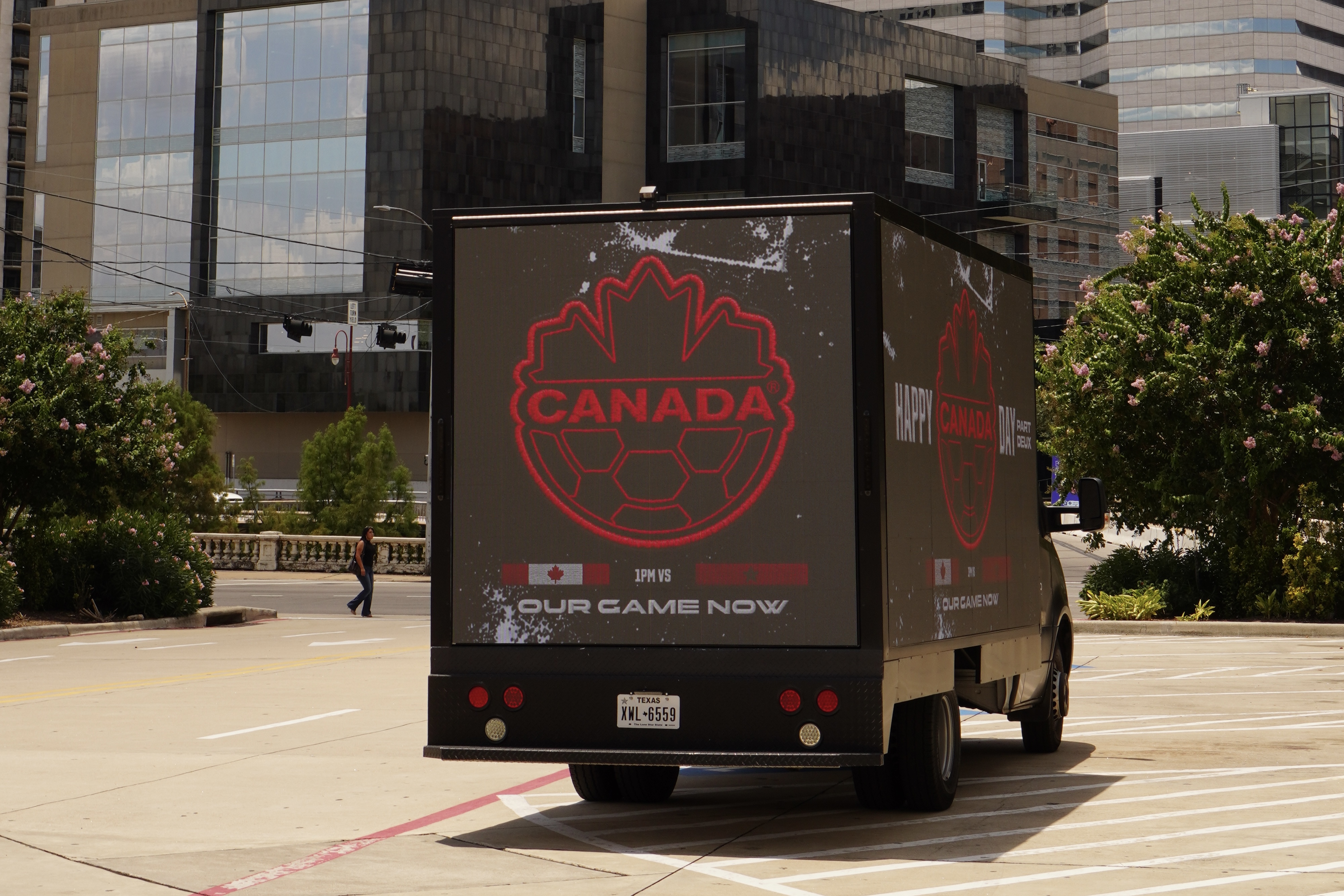 Motivo mobile marketing vehicle displaying a Canada World Cup promotional ad in downtown Houston