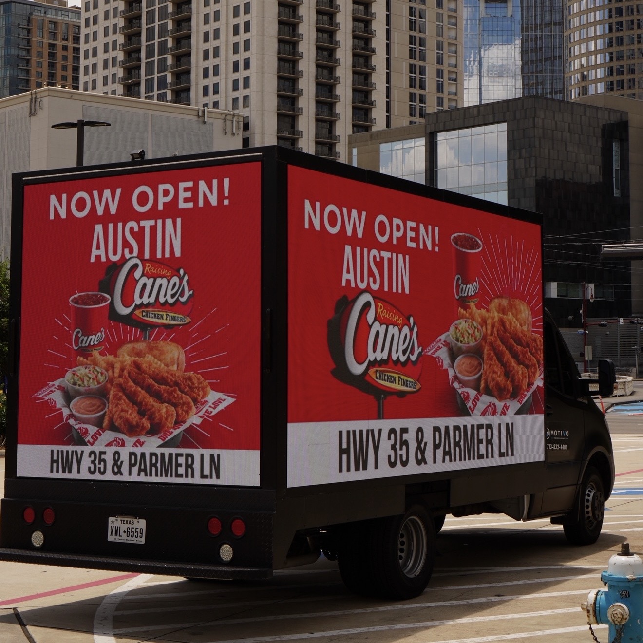 Motivo mobile billboard truck running a Raising Cane's grand opening campaign on LED screens in Austin, Texas