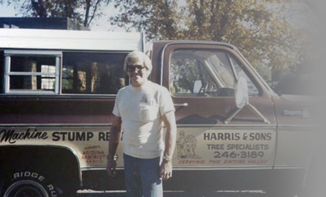 Norm Harris, original founder of Harris & Sons Tree Specialists, with the company's vintage tree service truck in Phoenix, Arizona