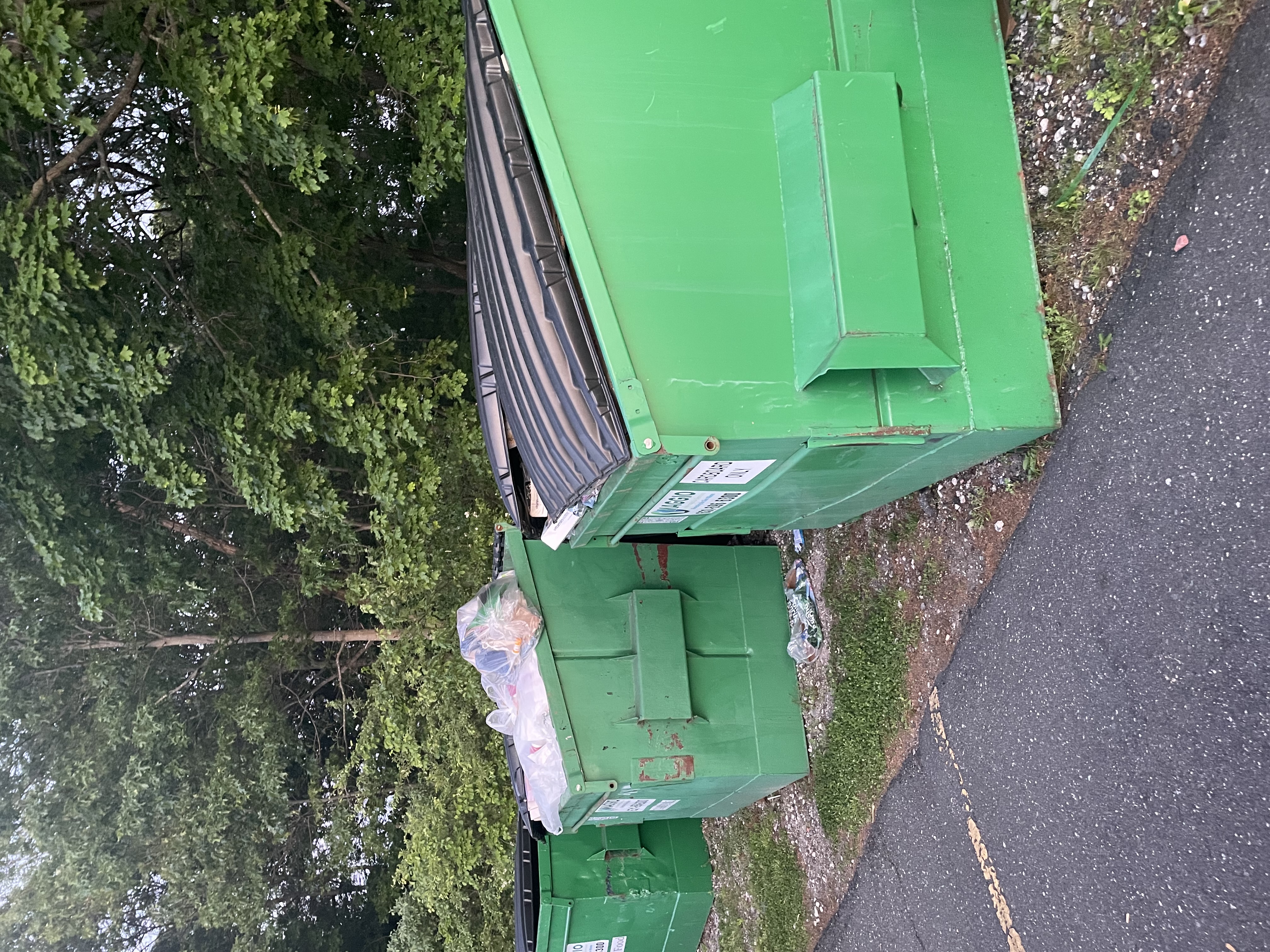 Overflowing dumpster containers ready for junk removal in Patchogue NY