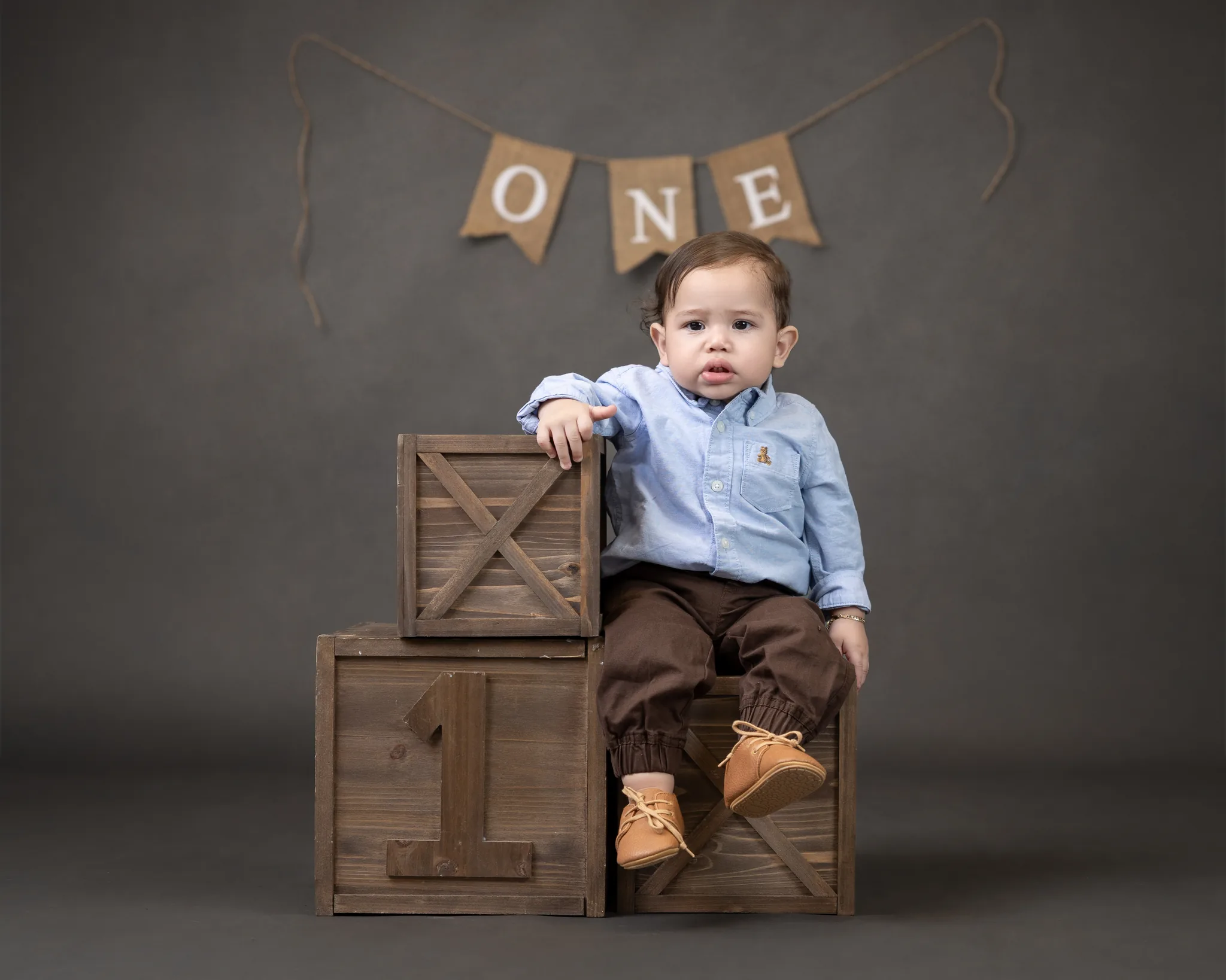 First birthday session with rustic wooden crates and ONE banner
