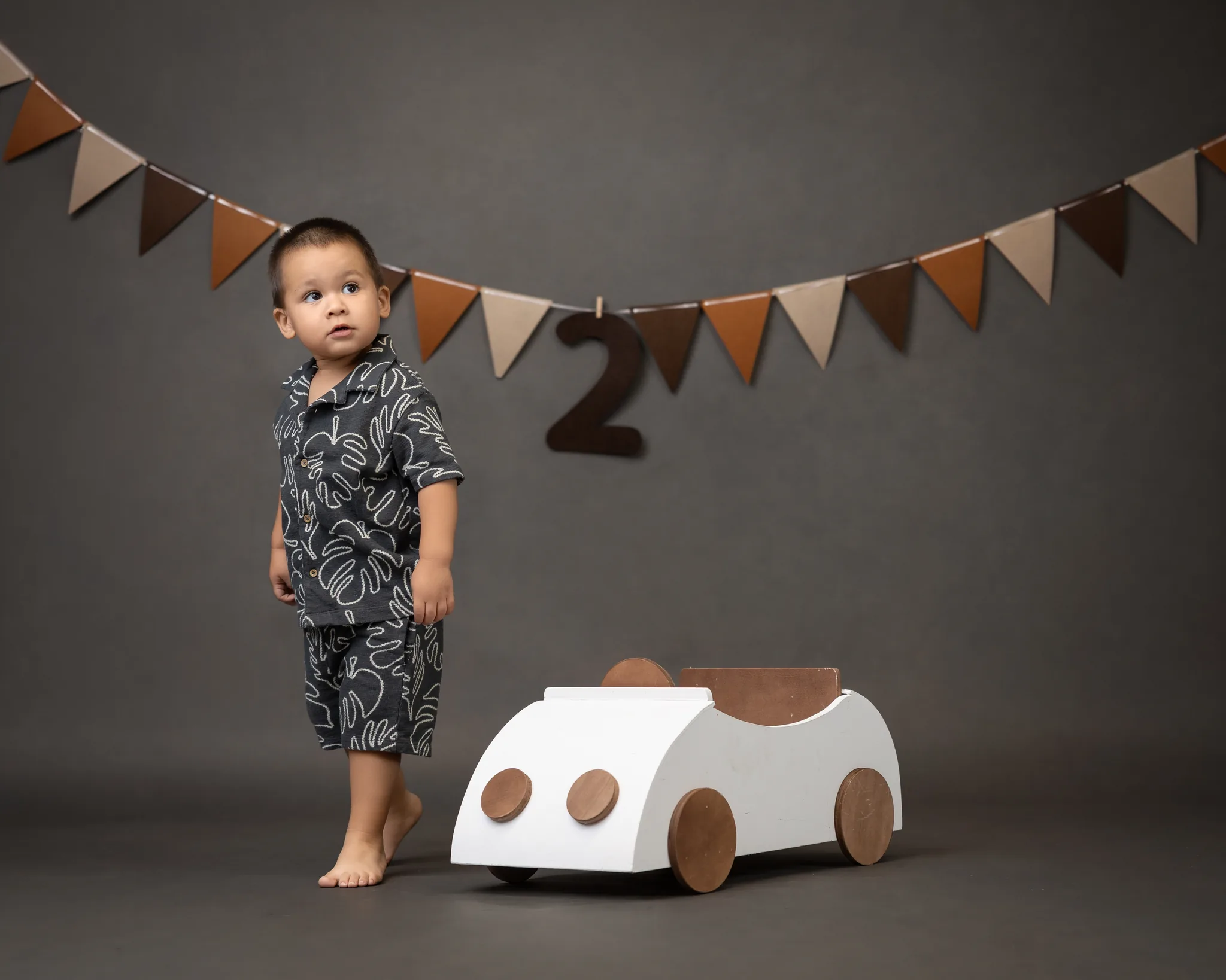 Second birthday tropical theme with toy car and bunting flags