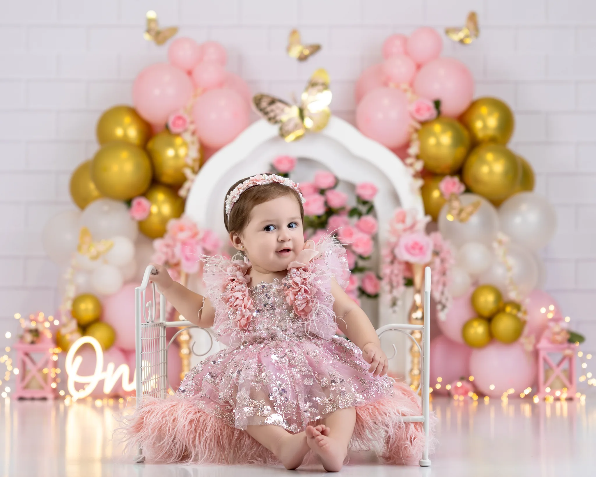 Pink princess first birthday with sequin dress and feather details
