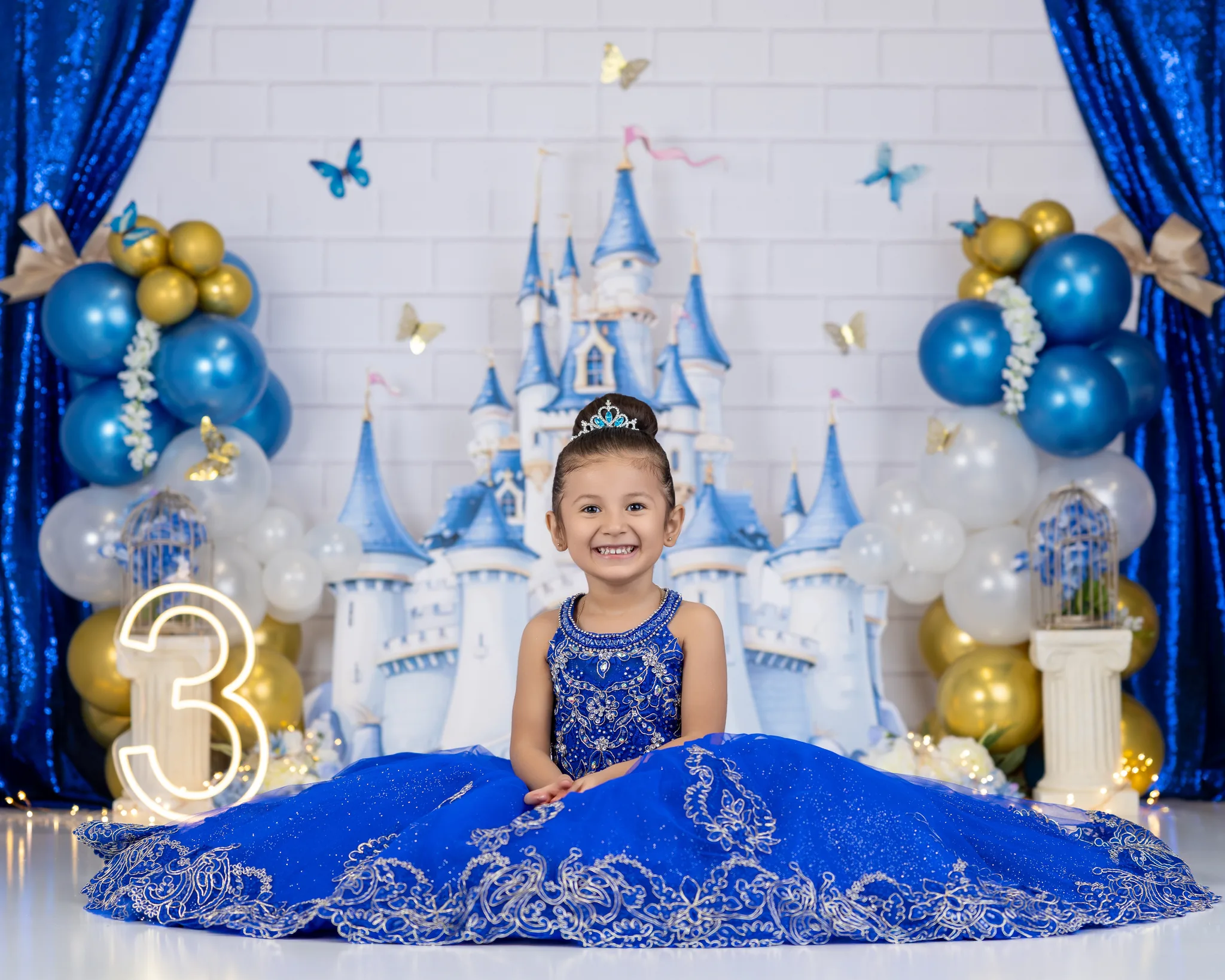 Royal blue princess 3rd birthday session with castle backdrop and tiara
