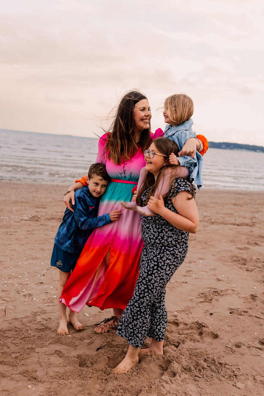Beth hugging her children on the beach