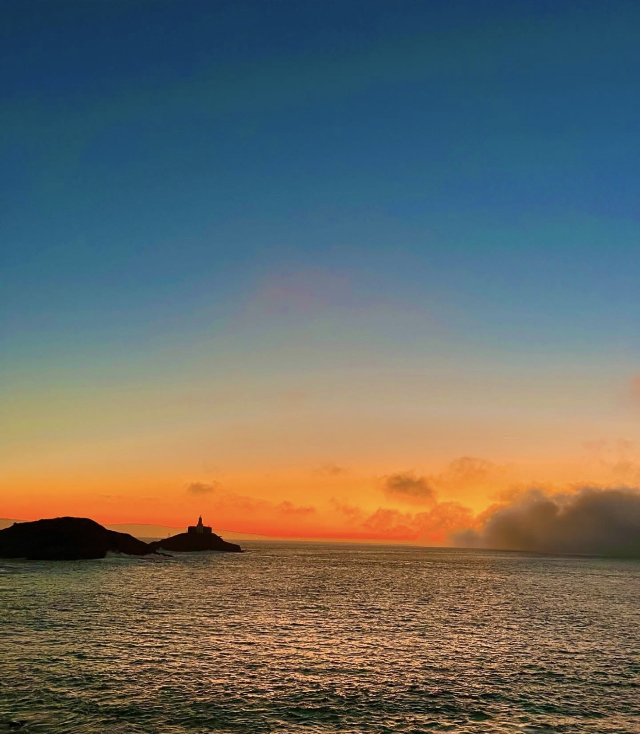 Mumbles Lighthouse at sunset in Swansea Bay