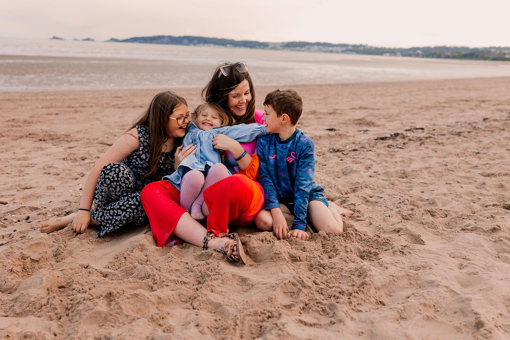 Beth Thomas with her children on the beach at Swansea Bay.