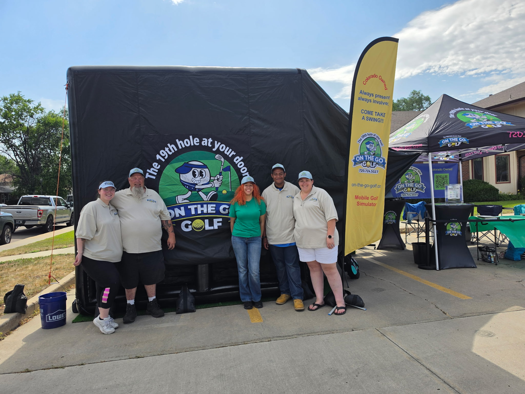 Staff posing in front of tent