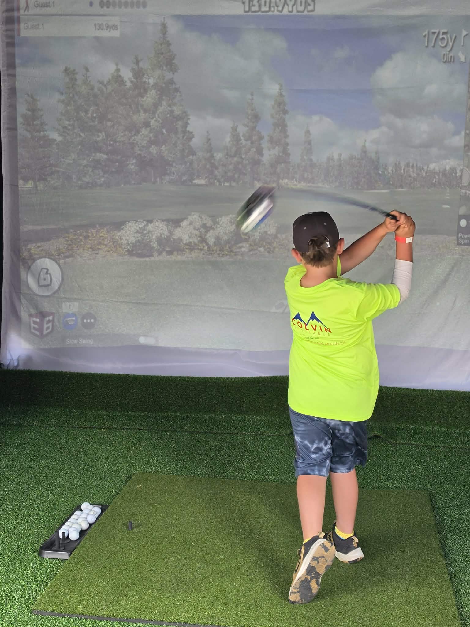 Kid swinging golf club