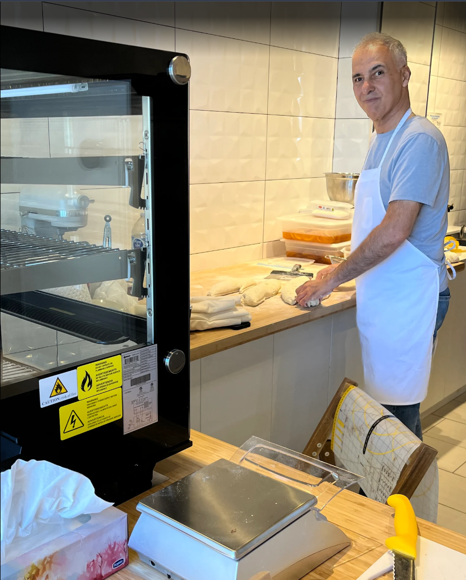 Master baker Masoud Emadi preparing signature pastries at Ganash Bakery