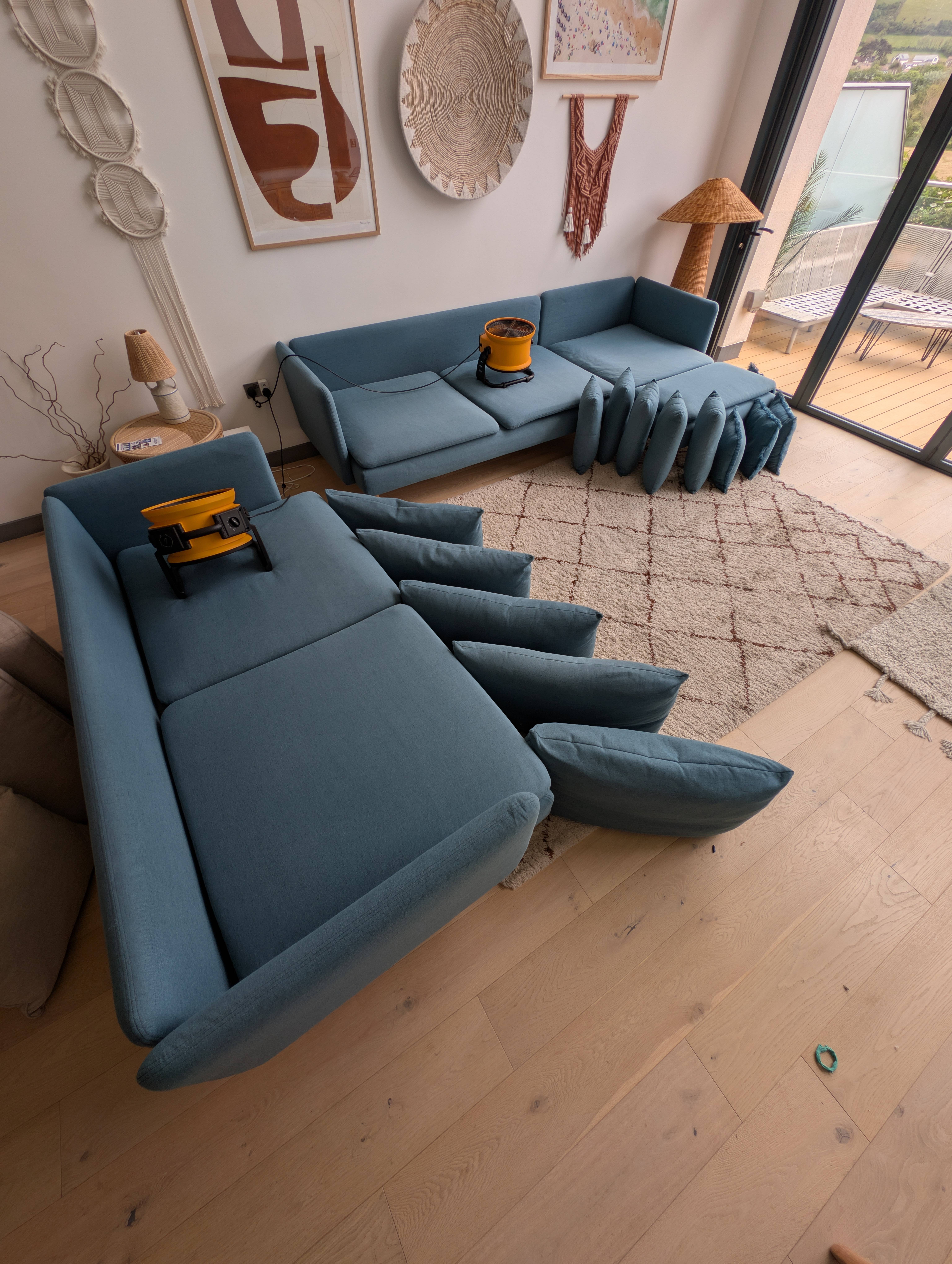 Professional sofa cleaning service in progress on blue sectional