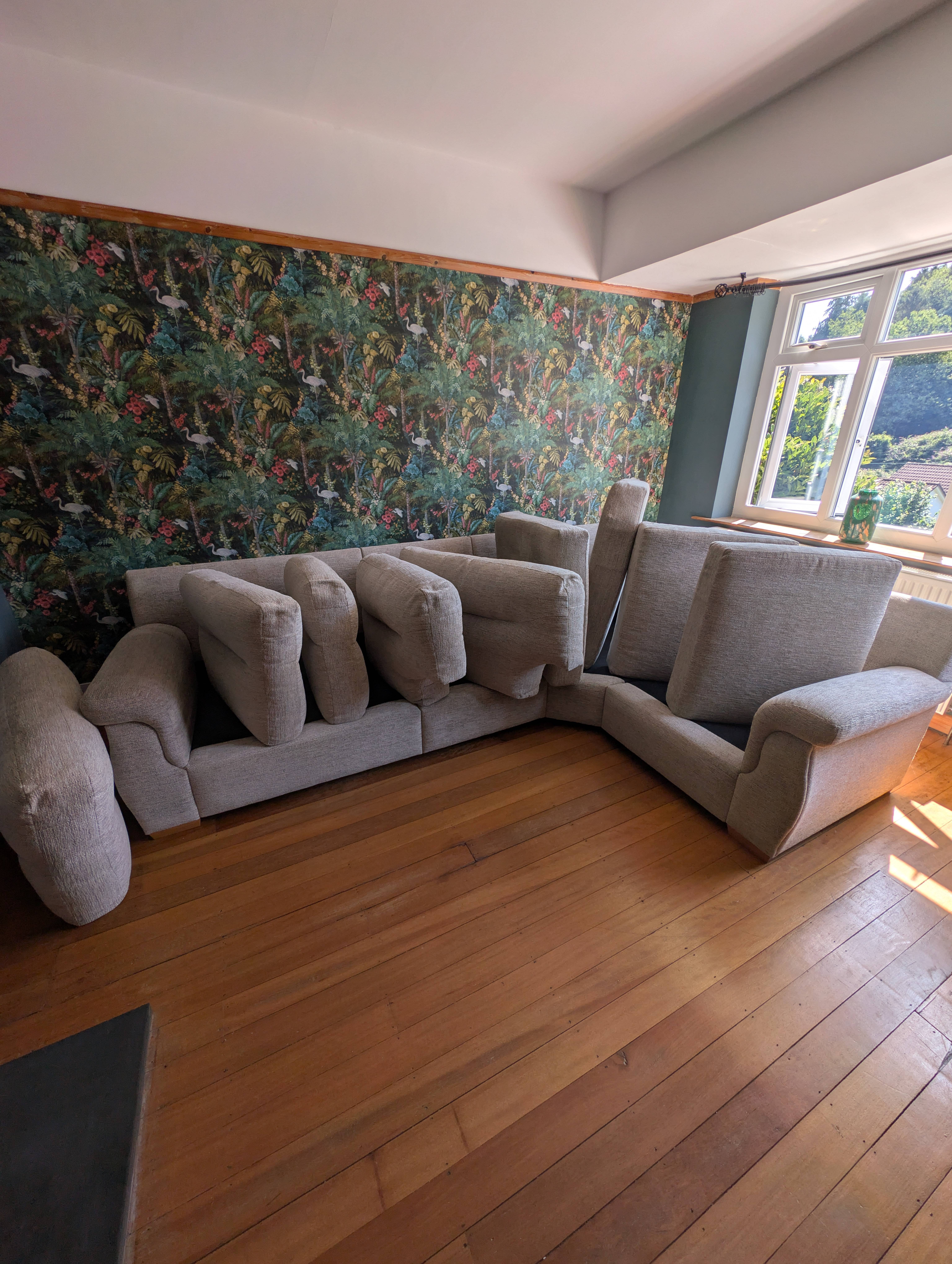 Large corner sofa prepared for professional upholstery cleaning