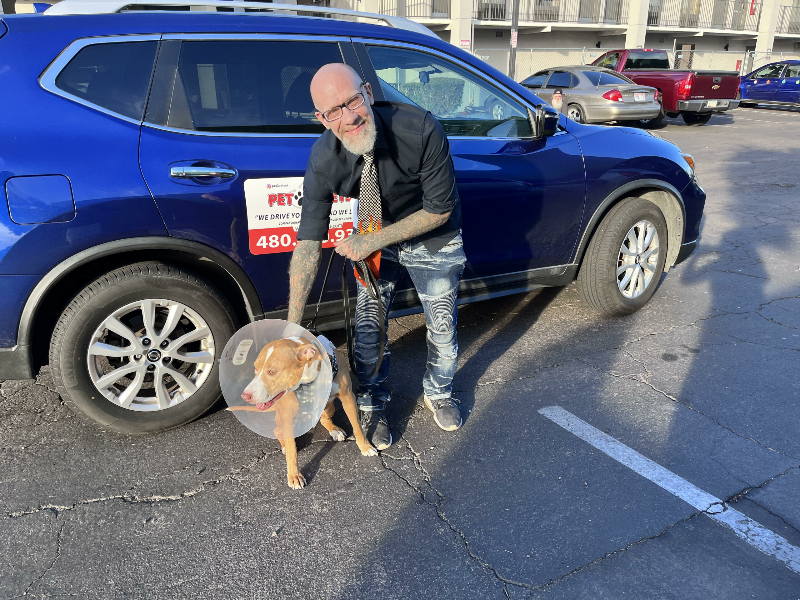 Man with dog next to Pet2Vets vehicle