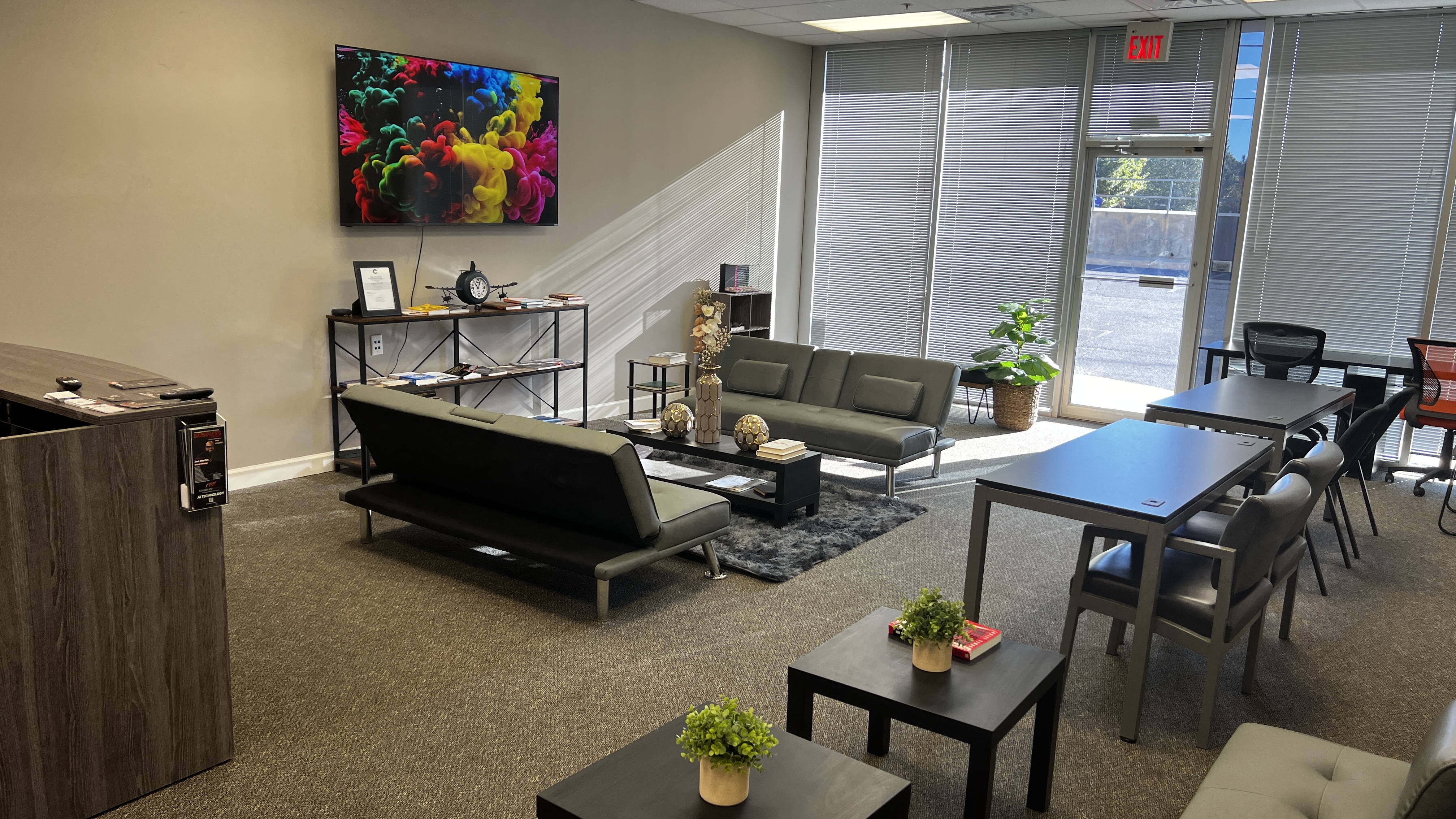 Client meeting lounge seating, coffee table, and natural daylight work area at Conyers GA Business Resource Center