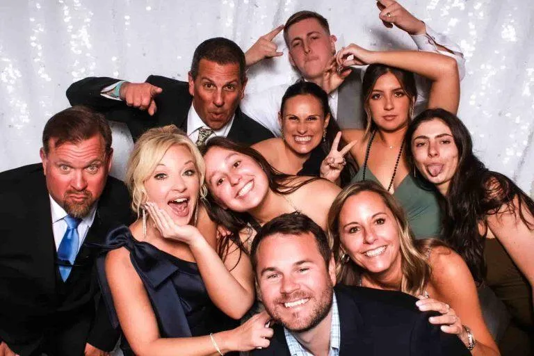 Guests making playful faces at a Photo-N-Go milestone celebration