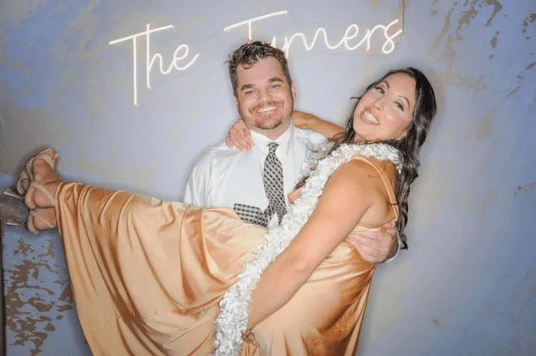 Happy couple posing together at a Photo-N-Go milestone event