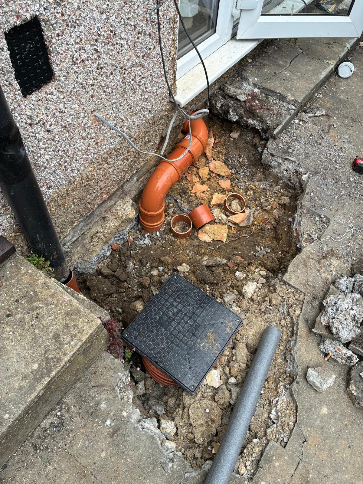 Underground drainage excavation with inspection chamber