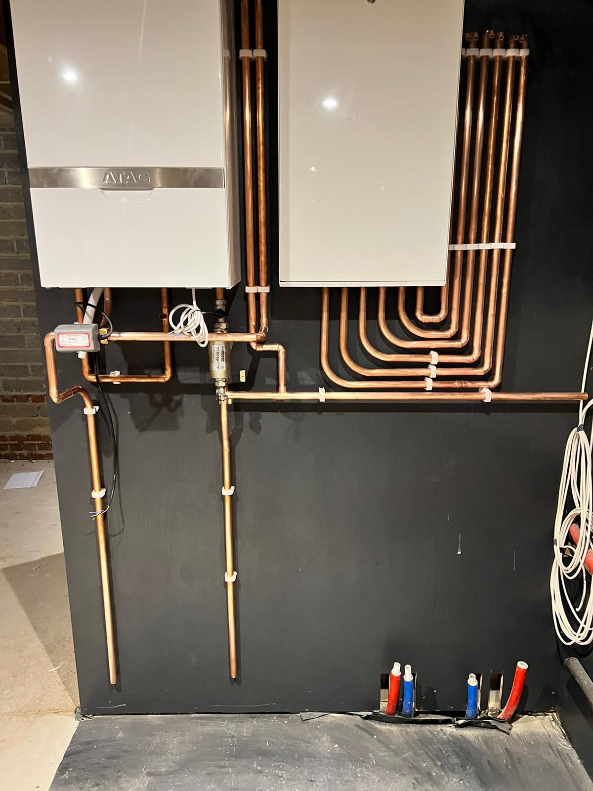 Wall-mounted ATAG boiler with neat copper pipework