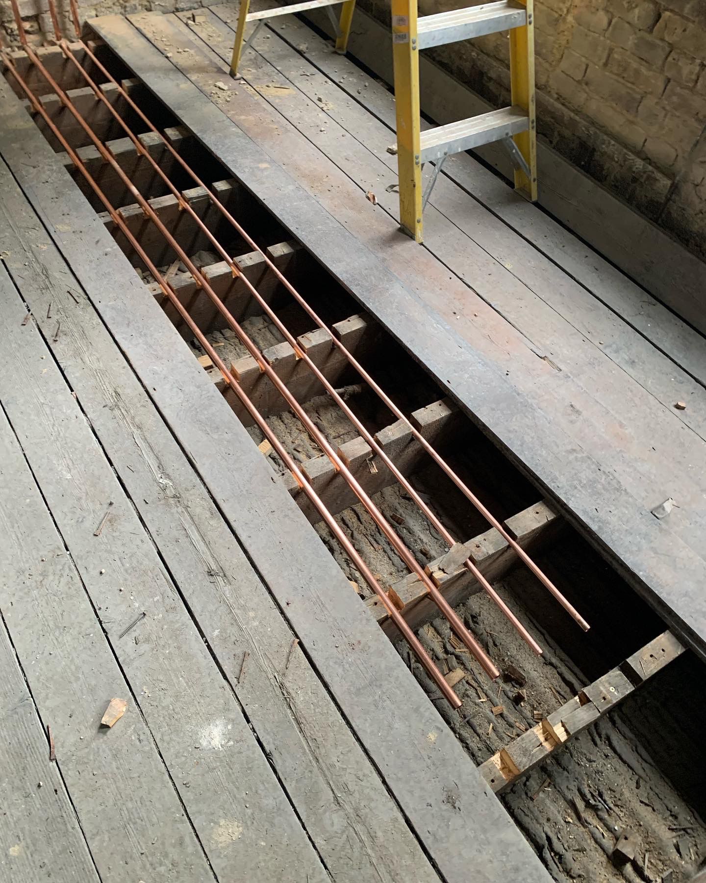 Copper pipework installed between floor joists