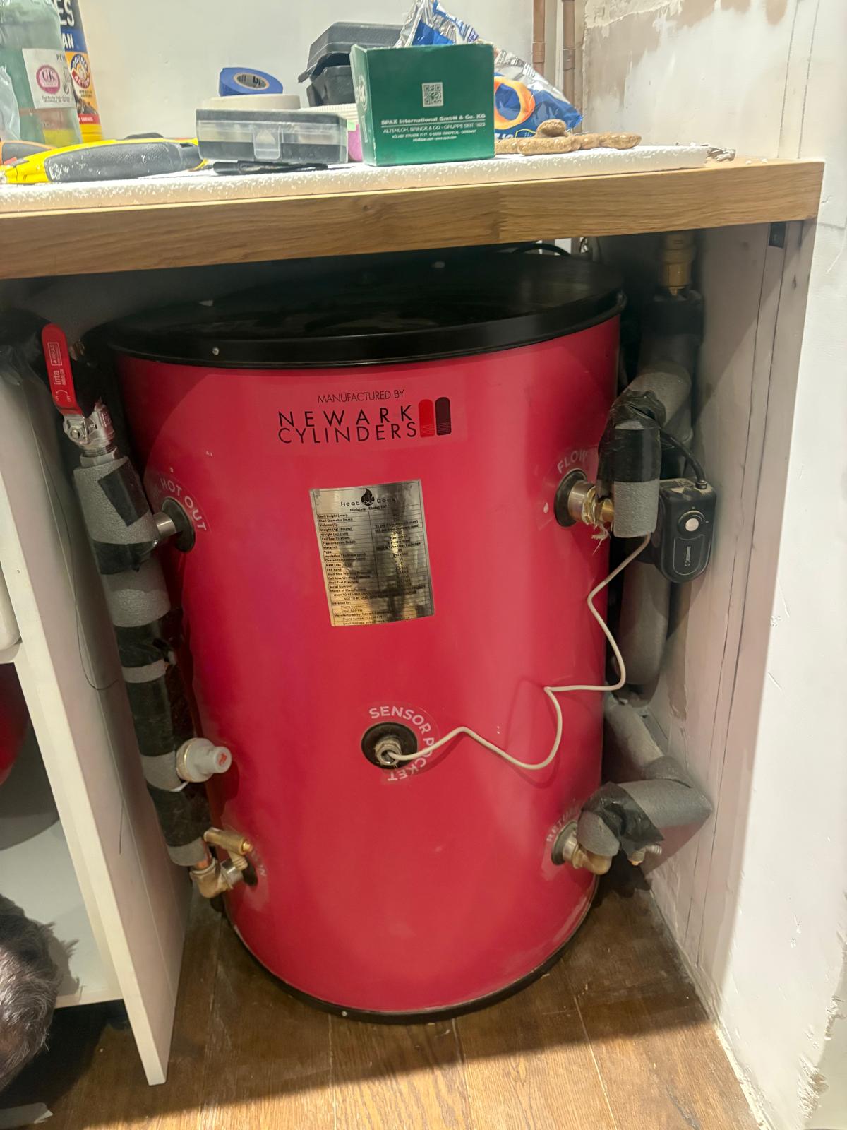 Pink Newark hot water cylinder with sensor pocket and insulated pipework