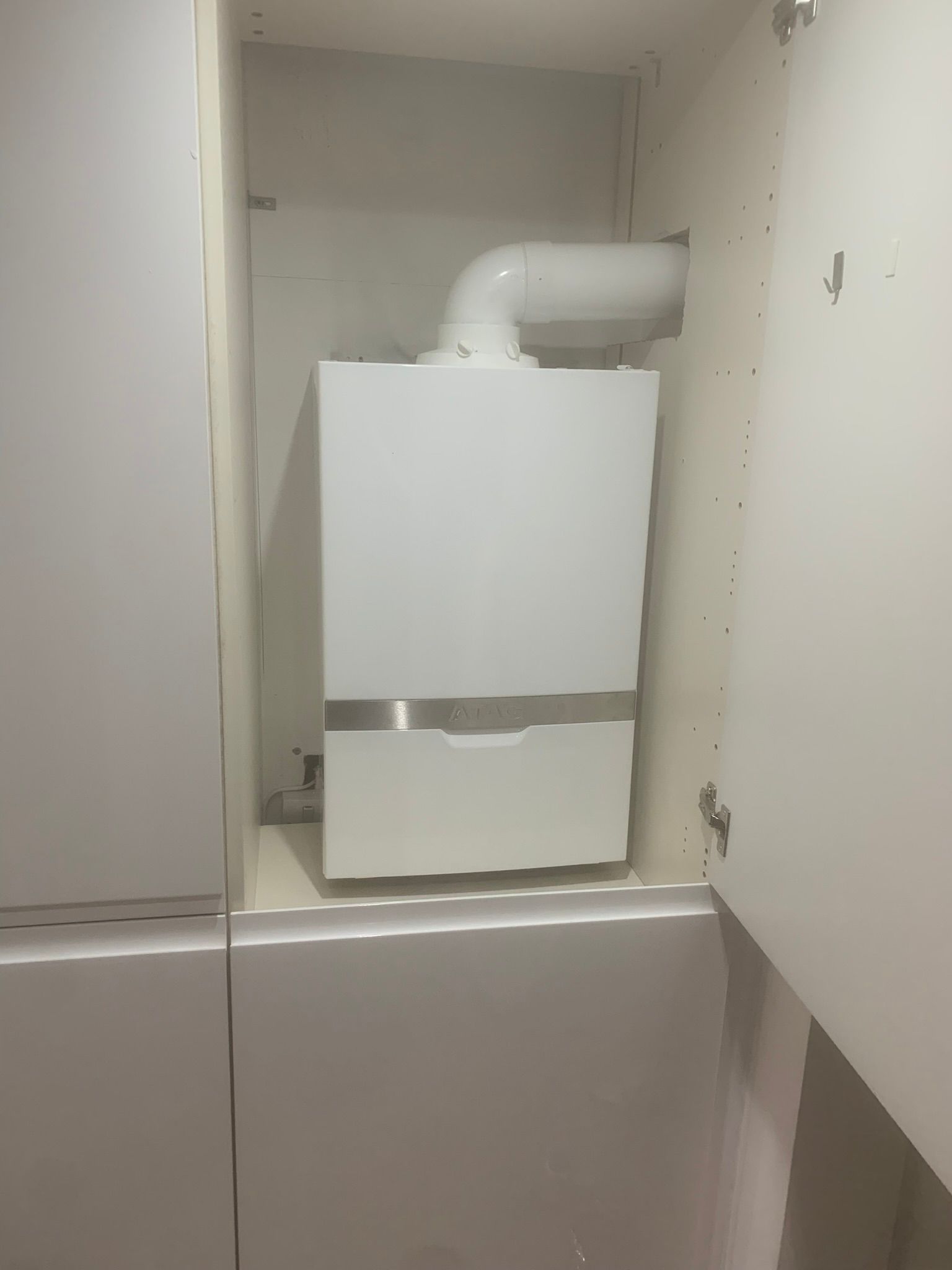 Modern boiler installation in cupboard